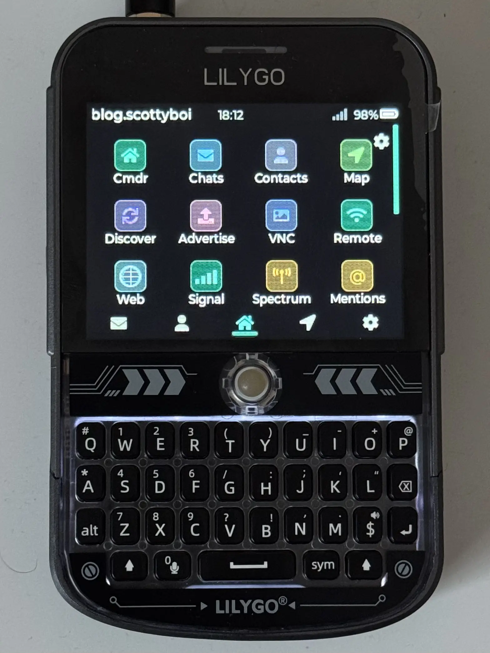 a photo of a t-deck running the wadamesh firmware. a grid of applications can be seen, including chats, contacts, and maps