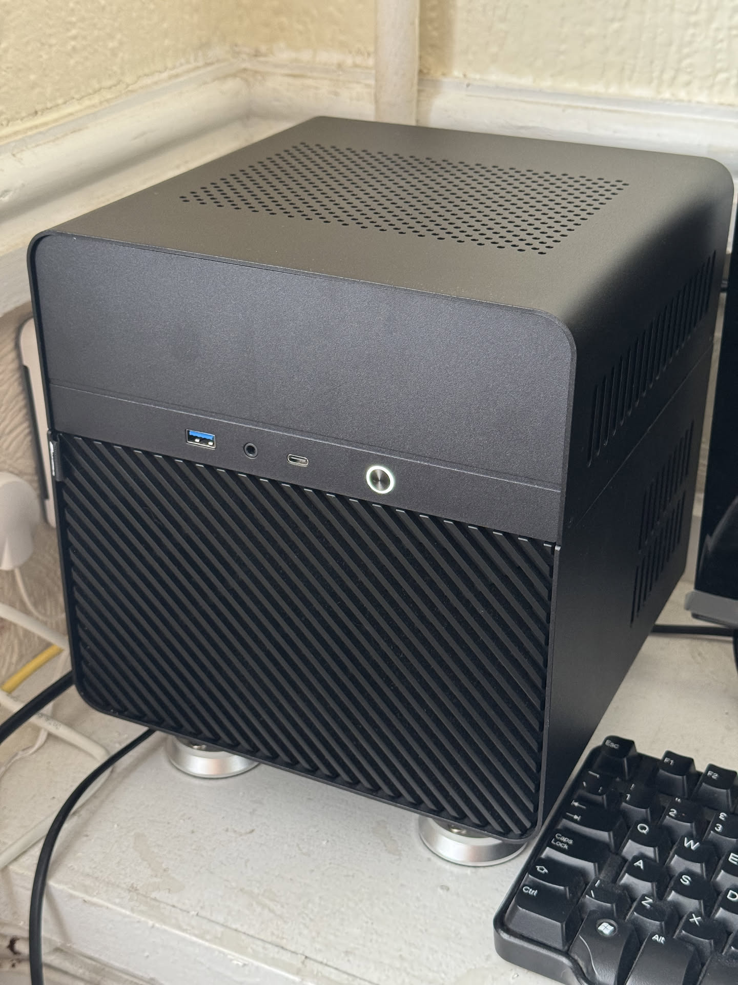 a photograph of a black, cube-shaped server